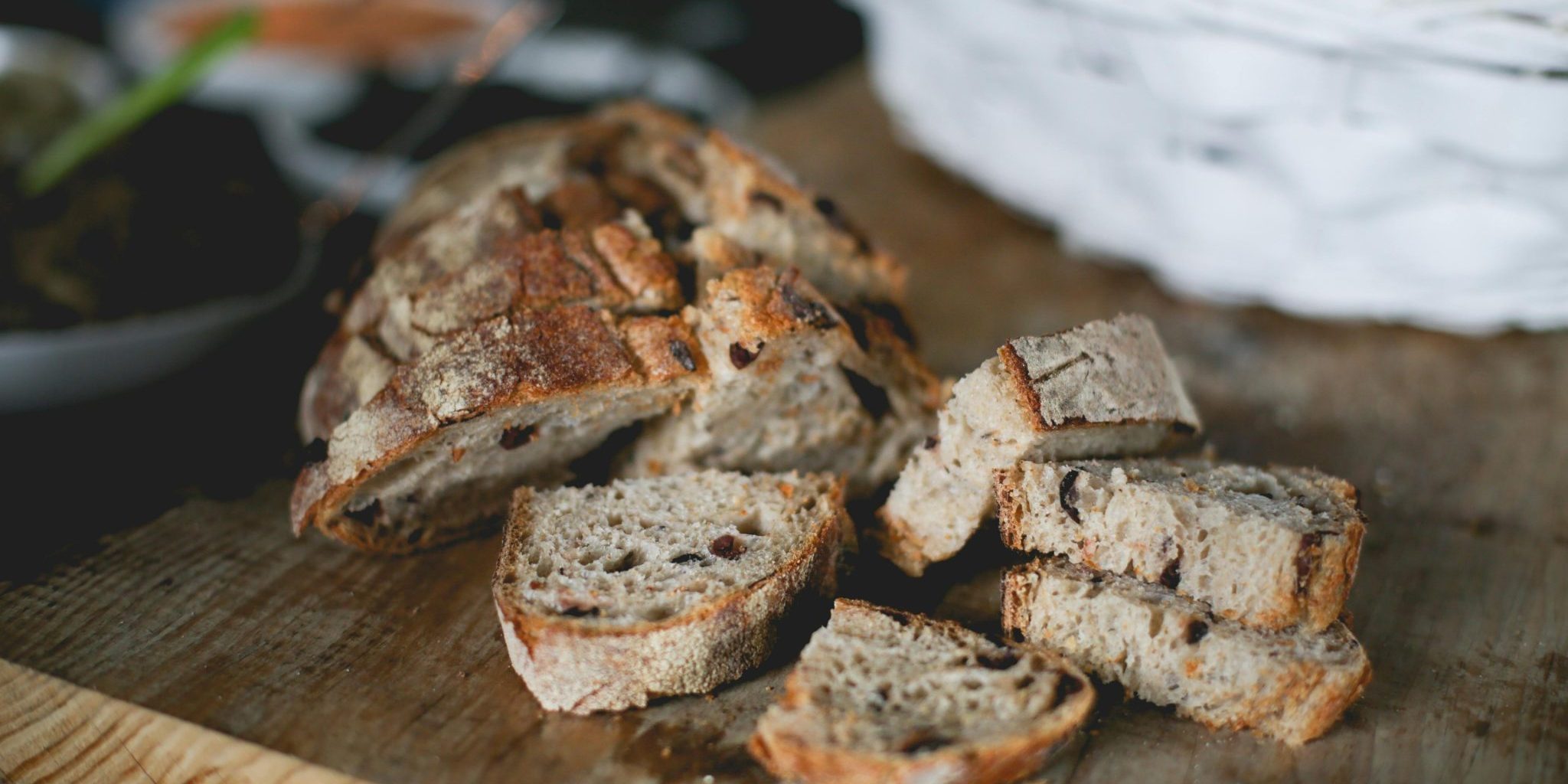 Illustration image. Whole-grain bread on a wooden cutting board.